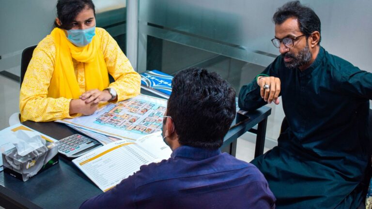 Pakistani team working around a table in an office