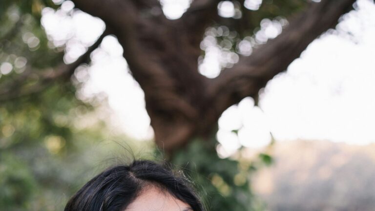 Young Pakistani woman smiling outdoors